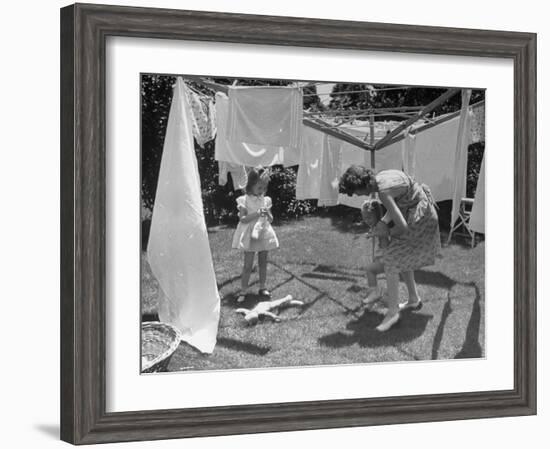 Suburban Mother Playing with Her Two Daughters While Hanging Laundry in Backyard-Alfred Eisenstaedt-Framed Photographic Print