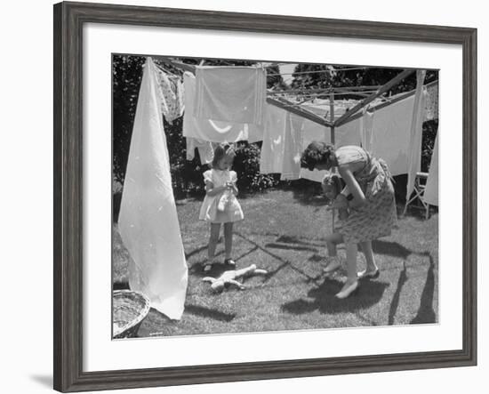 Suburban Mother Playing with Her Two Daughters While Hanging Laundry in Backyard-Alfred Eisenstaedt-Framed Photographic Print