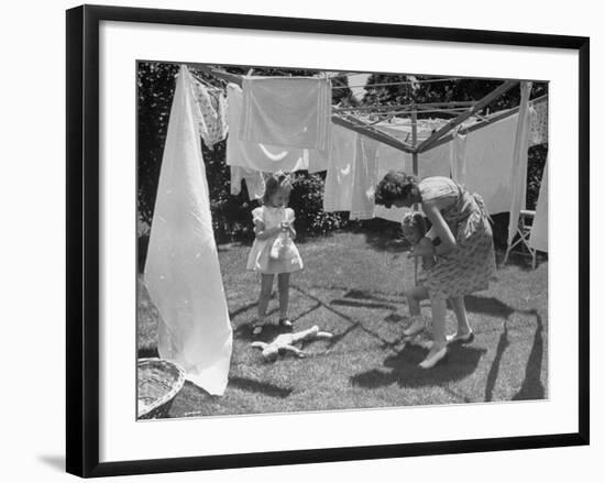 Suburban Mother Playing with Her Two Daughters While Hanging Laundry in Backyard-Alfred Eisenstaedt-Framed Photographic Print