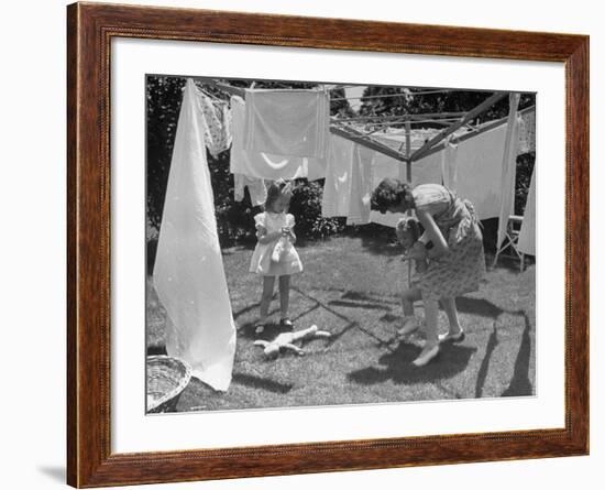 Suburban Mother Playing with Her Two Daughters While Hanging Laundry in Backyard-Alfred Eisenstaedt-Framed Photographic Print