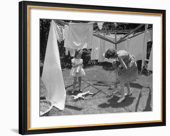 Suburban Mother Playing with Her Two Daughters While Hanging Laundry in Backyard-Alfred Eisenstaedt-Framed Photographic Print