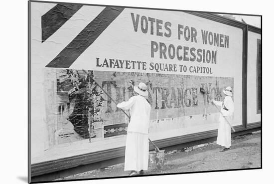 Suffragettes Uses Long Brushes To Post a Billboard Announcing a "Votes" For Women" Parade-null-Mounted Art Print