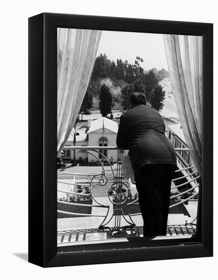 Suit Clad Movie Director Alfred Hitchcock as He Leans on Balcony Railing of Apartment-Peter Stackpole-Framed Premier Image Canvas