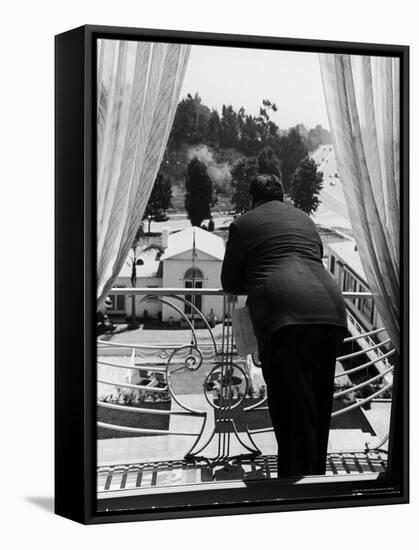 Suit Clad Movie Director Alfred Hitchcock as He Leans on Balcony Railing of Apartment-Peter Stackpole-Framed Premier Image Canvas