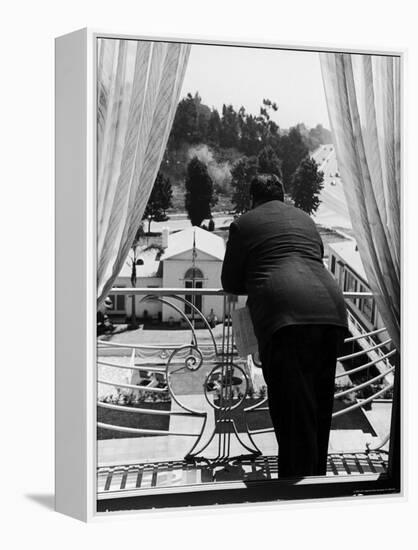 Suit Clad Movie Director Alfred Hitchcock as He Leans on Balcony Railing of Apartment-Peter Stackpole-Framed Premier Image Canvas