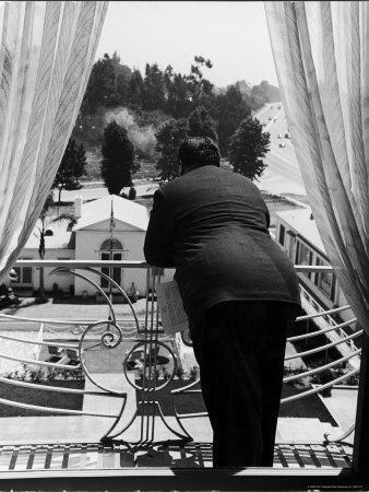 Suit Clad Movie Director Alfred Hitchcock as He Leans on Balcony Railing of  Apartment' Premium Photographic Print - Peter Stackpole | Art.com