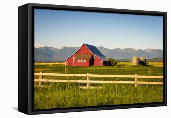 Summer Evening with a Red Barn and Silos in Rural Montana with Rocky Mountains in the Background.-Nick Fox-Framed Premier Image Canvas