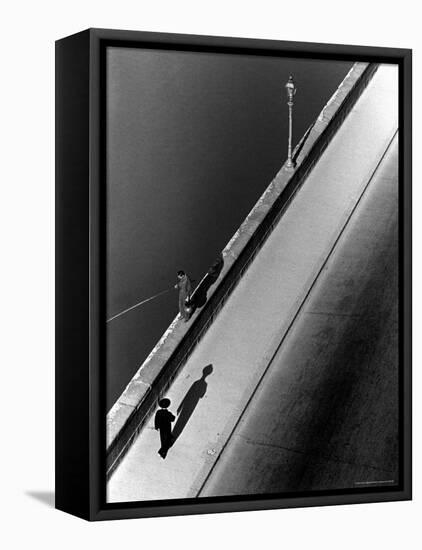 Sunday Morning Along the Arno River, a Man Fishing, and a Passerby Casting a Shadow-Alfred Eisenstaedt-Framed Premier Image Canvas