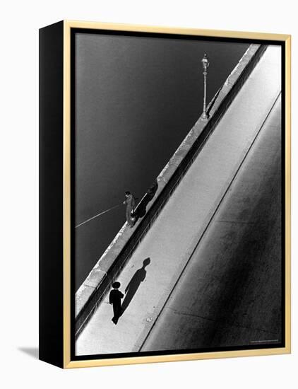 Sunday Morning Along the Arno River, a Man Fishing, and a Passerby Casting a Shadow-Alfred Eisenstaedt-Framed Premier Image Canvas