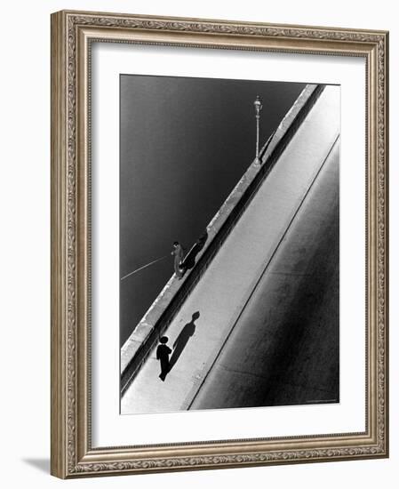 Sunday Morning Along the Arno River, a Man Fishing, and a Passerby Casting a Shadow-Alfred Eisenstaedt-Framed Photographic Print