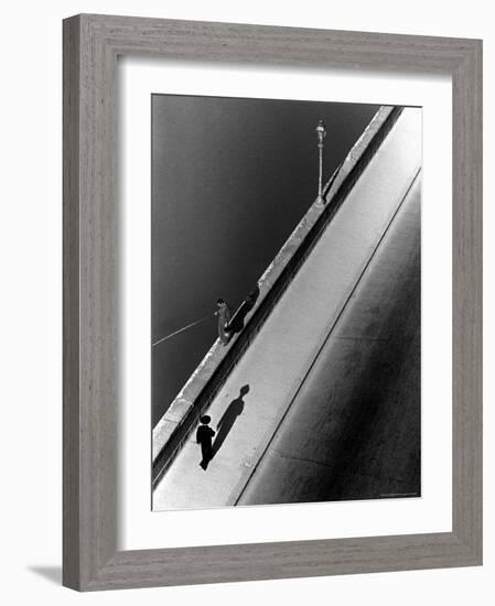 Sunday Morning Along the Arno River, a Man Fishing, and a Passerby Casting a Shadow-Alfred Eisenstaedt-Framed Photographic Print