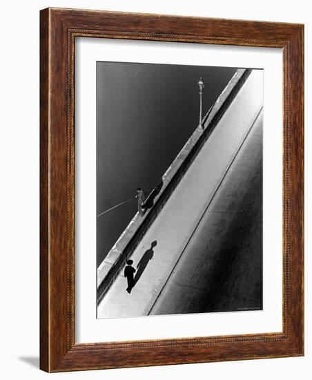 Sunday Morning Along the Arno River, a Man Fishing, and a Passerby Casting a Shadow-Alfred Eisenstaedt-Framed Photographic Print