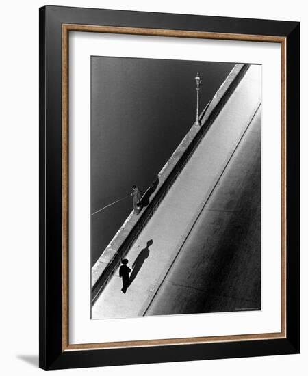 Sunday Morning Along the Arno River, a Man Fishing, and a Passerby Casting a Shadow-Alfred Eisenstaedt-Framed Photographic Print