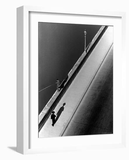 Sunday Morning Along the Arno River, a Man Fishing, and a Passerby Casting a Shadow-Alfred Eisenstaedt-Framed Photographic Print