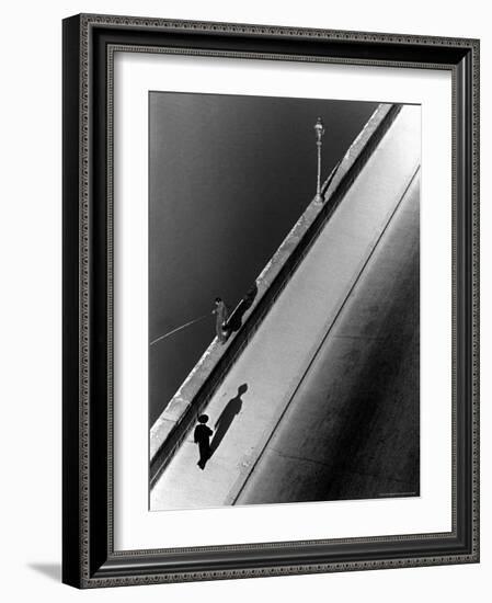Sunday Morning Along the Arno River, a Man Fishing, and a Passerby Casting a Shadow-Alfred Eisenstaedt-Framed Photographic Print