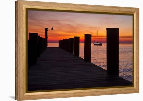 Sunrise on the Water with an Empty Dock and a Sailboat in the Distance of Tilghman Island, Maryland-Karine Aigner-Framed Premier Image Canvas