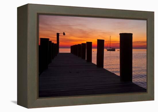 Sunrise on the Water with an Empty Dock and a Sailboat in the Distance of Tilghman Island, Maryland-Karine Aigner-Framed Premier Image Canvas