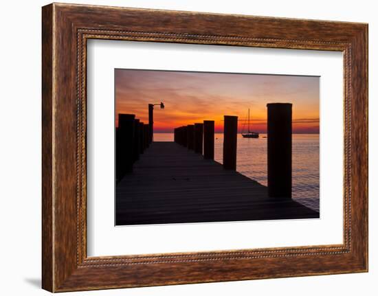 Sunrise on the Water with an Empty Dock and a Sailboat in the Distance of Tilghman Island, Maryland-Karine Aigner-Framed Photographic Print