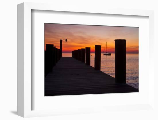 Sunrise on the Water with an Empty Dock and a Sailboat in the Distance of Tilghman Island, Maryland-Karine Aigner-Framed Photographic Print