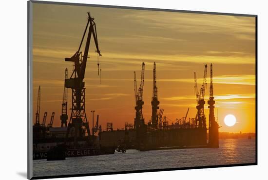 Sunset Above the Elbe with the Scenery of the Shipyard Cranes in the Swimming Dock-Uwe Steffens-Mounted Photographic Print