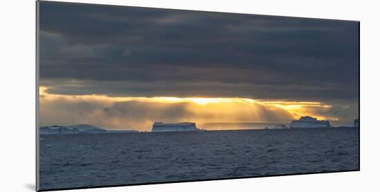 Sunset over icebergs, Antarctica-Art Wolfe-Mounted Photographic Print