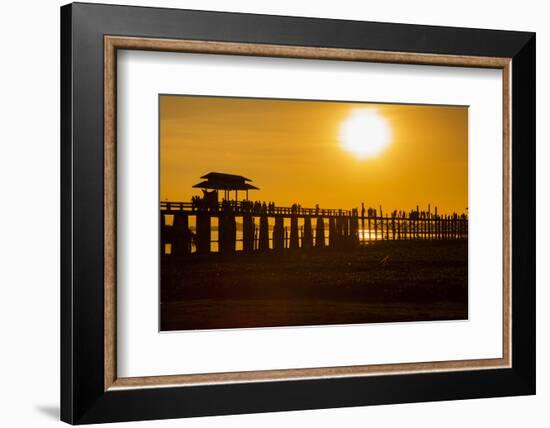 Sunset over the lake near wooden footbridge, Myanmar.-Michele Niles-Framed Photographic Print