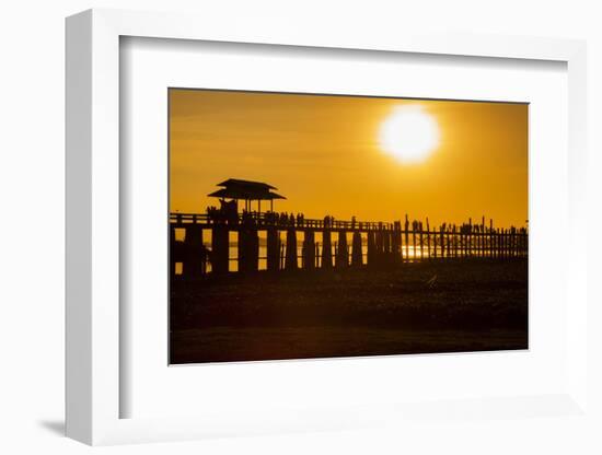 Sunset over the lake near wooden footbridge, Myanmar.-Michele Niles-Framed Photographic Print