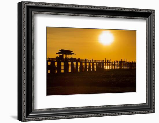 Sunset over the lake near wooden footbridge, Myanmar.-Michele Niles-Framed Photographic Print