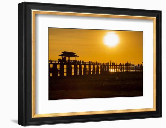 Sunset over the lake near wooden footbridge, Myanmar.-Michele Niles-Framed Photographic Print