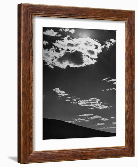 Sunshine Filled Clouds Against Dark Sky, Above Dark Dune in Middle of Kalahan Desert, Bechuanaland-Nat Farbman-Framed Photographic Print
