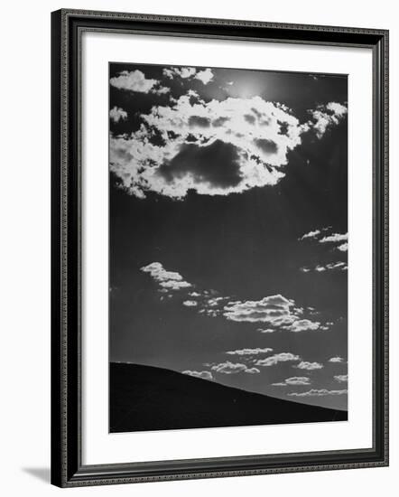 Sunshine Filled Clouds Against Dark Sky, Above Dark Dune in Middle of Kalahan Desert, Bechuanaland-Nat Farbman-Framed Photographic Print