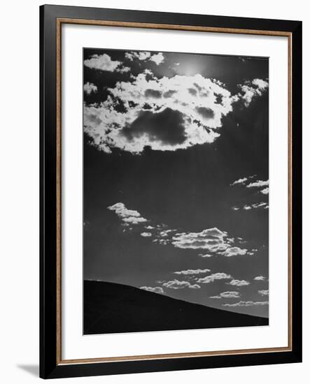 Sunshine Filled Clouds Against Dark Sky, Above Dark Dune in Middle of Kalahan Desert, Bechuanaland-Nat Farbman-Framed Photographic Print