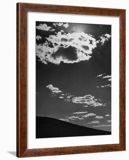 Sunshine Filled Clouds Against Dark Sky, Above Dark Dune in Middle of Kalahan Desert, Bechuanaland-Nat Farbman-Framed Photographic Print