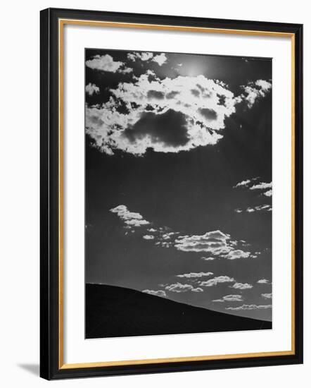 Sunshine Filled Clouds Against Dark Sky, Above Dark Dune in Middle of Kalahan Desert, Bechuanaland-Nat Farbman-Framed Photographic Print