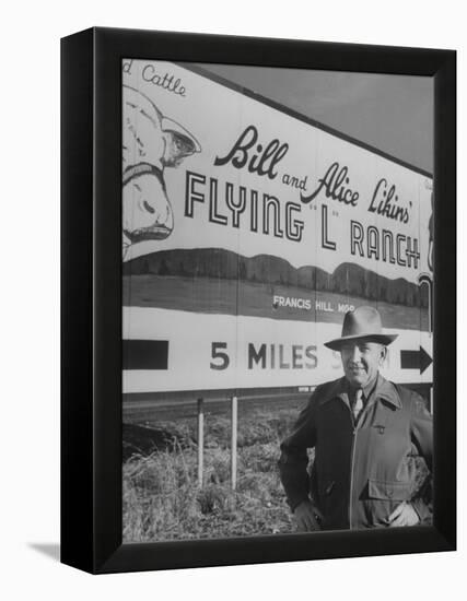 Super Rich Texas Millionaires William Likins Standing in Front of Sign at Main Entrance to Ranch-Michael Rougier-Framed Premier Image Canvas