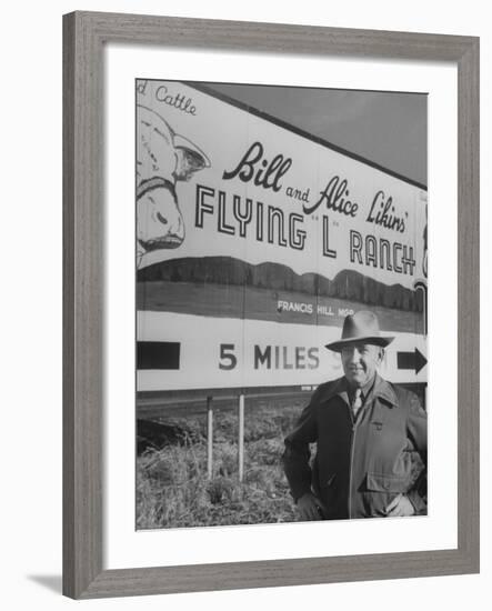 Super Rich Texas Millionaires William Likins Standing in Front of Sign at Main Entrance to Ranch-Michael Rougier-Framed Premium Photographic Print