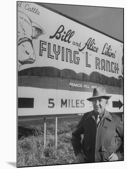 Super Rich Texas Millionaires William Likins Standing in Front of Sign at Main Entrance to Ranch-Michael Rougier-Mounted Premium Photographic Print