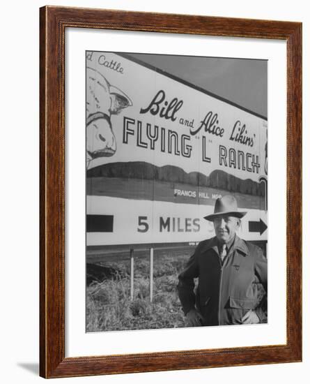 Super Rich Texas Millionaires William Likins Standing in Front of Sign at Main Entrance to Ranch-Michael Rougier-Framed Premium Photographic Print