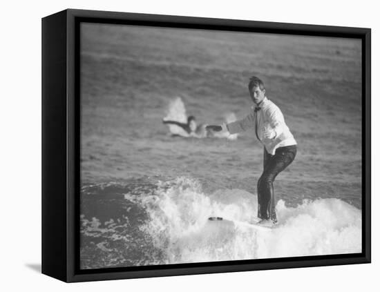 Surfer Riding a Wave While Wearing a Tuxedo-Allan Grant-Framed Premier Image Canvas