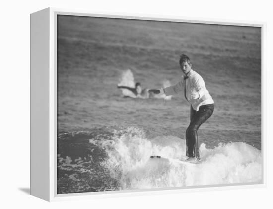 Surfer Riding a Wave While Wearing a Tuxedo-Allan Grant-Framed Premier Image Canvas