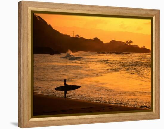 Surfer Standing at Waimea Bay at Sunset, Waimea, U.S.A.-Ann Cecil-Framed Premier Image Canvas