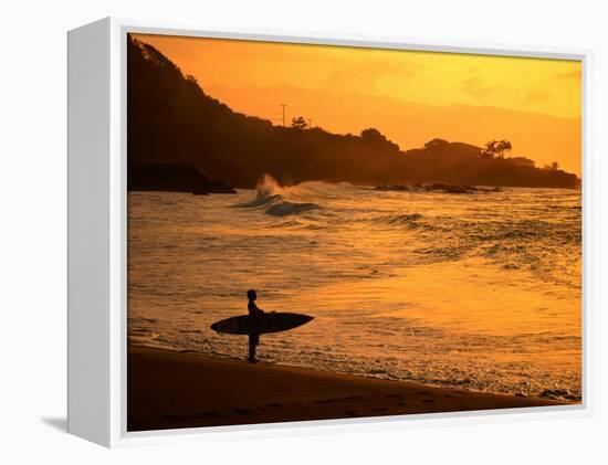 Surfer Standing at Waimea Bay at Sunset, Waimea, U.S.A.-Ann Cecil-Framed Premier Image Canvas