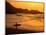 Surfer Standing at Waimea Bay at Sunset, Waimea, U.S.A.-Ann Cecil-Mounted Photographic Print