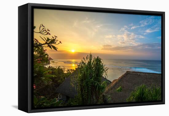 Surfers at sunset in Bali with straw roofed huts, Indonesia, Southeast Asia, Asia-Tyler Lillico-Framed Premier Image Canvas