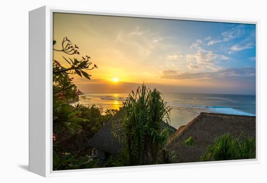 Surfers at sunset in Bali with straw roofed huts, Indonesia, Southeast Asia, Asia-Tyler Lillico-Framed Premier Image Canvas