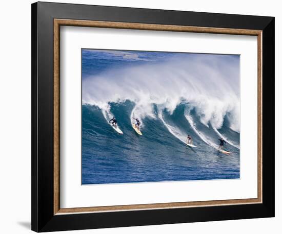 Surfers Ride a Wave at Waimea Beach on the North Shore of Oahu, Hawaii-null-Framed Photographic Print