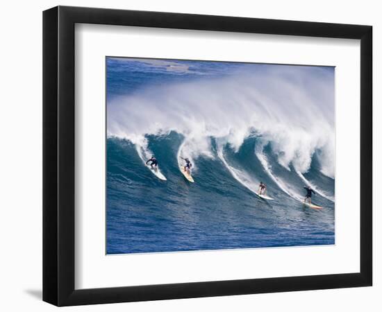 Surfers Ride a Wave at Waimea Beach on the North Shore of Oahu, Hawaii-null-Framed Photographic Print