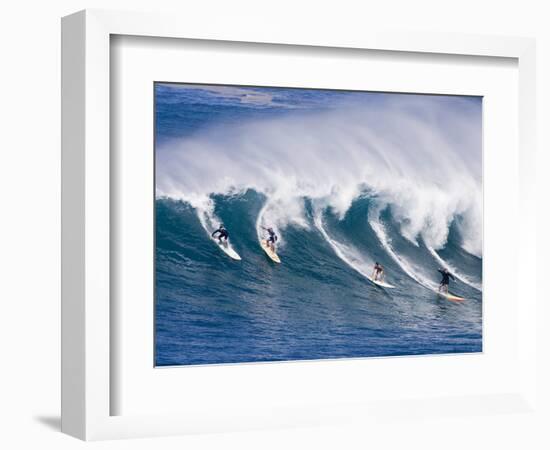 Surfers Ride a Wave at Waimea Beach on the North Shore of Oahu, Hawaii-null-Framed Photographic Print