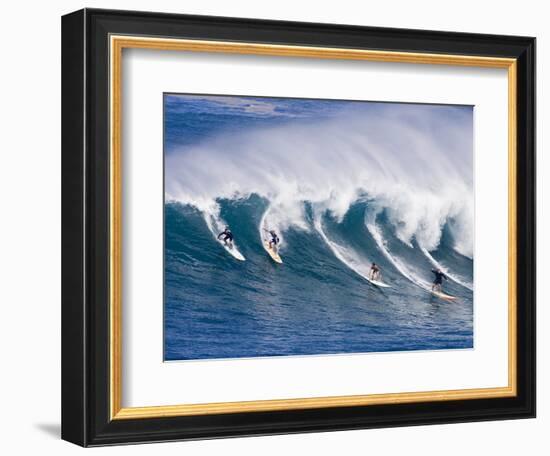 Surfers Ride a Wave at Waimea Beach on the North Shore of Oahu, Hawaii-null-Framed Photographic Print