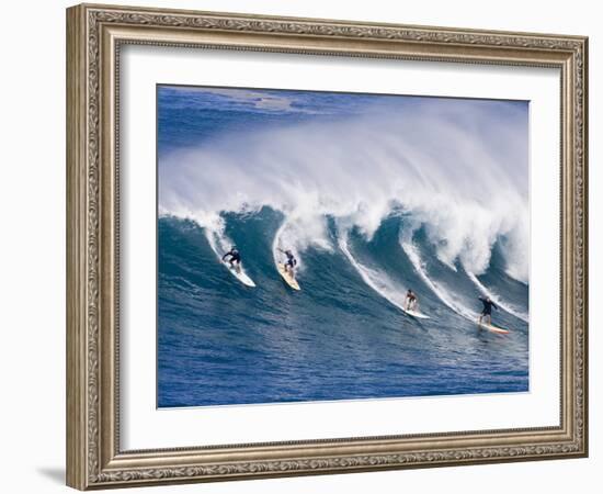 Surfers Ride a Wave at Waimea Beach on the North Shore of Oahu, Hawaii-null-Framed Photographic Print